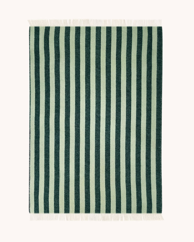 A full view of the reversed patten of the  Maison Deux Candy Stripe throw blanket, made from NZ wool, in shades of forest green and sage. 