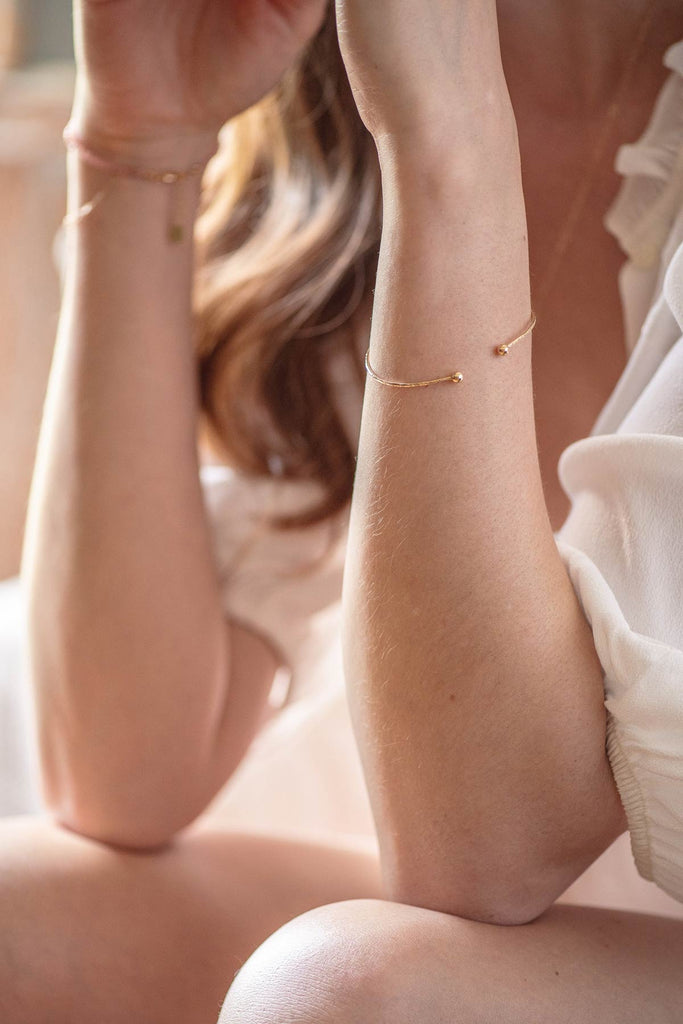 A minimalist cuff-style bangle, made with yellow gold fill by French jewellery designers Zoaje