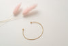 The Denmark bangle bracelet, made with yellow-gold fill and hammered into a beautiful minimalist cuff shape. 