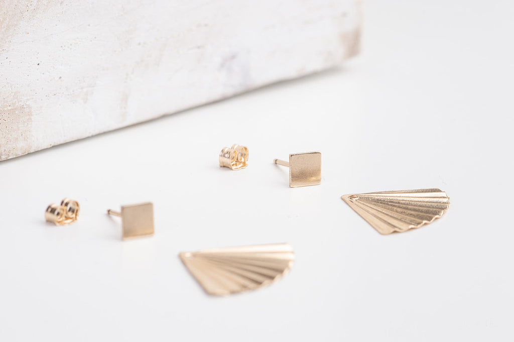The China earrings by Zoaje, with the jackets laid out, all components seperated. 