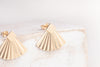 The China stud earrings in yellow-gold fill by Zoaje, with square studs and pleated jackets. 