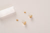 A top down view of the Nepal hexagon studs, in yellow gold-fill with butterfly backs. 