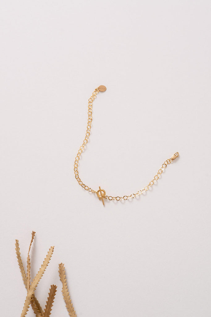 A fuller view of the Thailand bracelet made with 14k gold-fill hammered chain and displaying an elegant OT fastening. 
