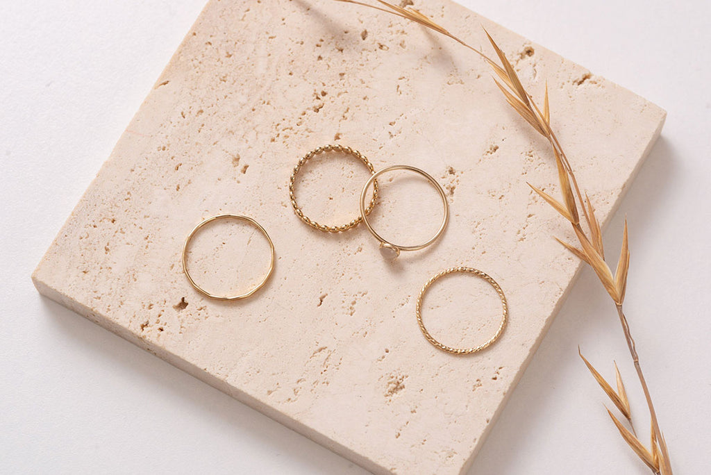 The Malaysia ring stack, seperated and viewed from above. The geometric textuality of the hammered gold rings contrasts with the simple delicacy of the feature stone ring. 