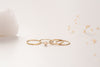 A side view of the rings that make up the Malaysia ring stack by Zoaje. The yellow gold-fill and natural white agate compliment the textures of the rings. 
