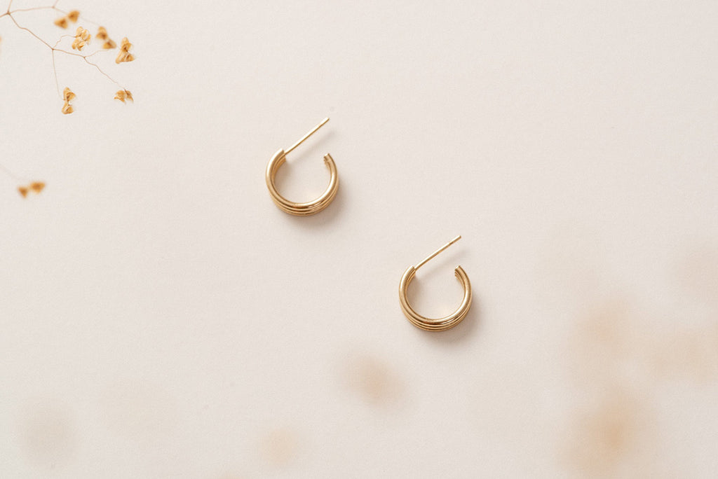 The Zoaje hoop earrings in Rouen, lying on their sides. 