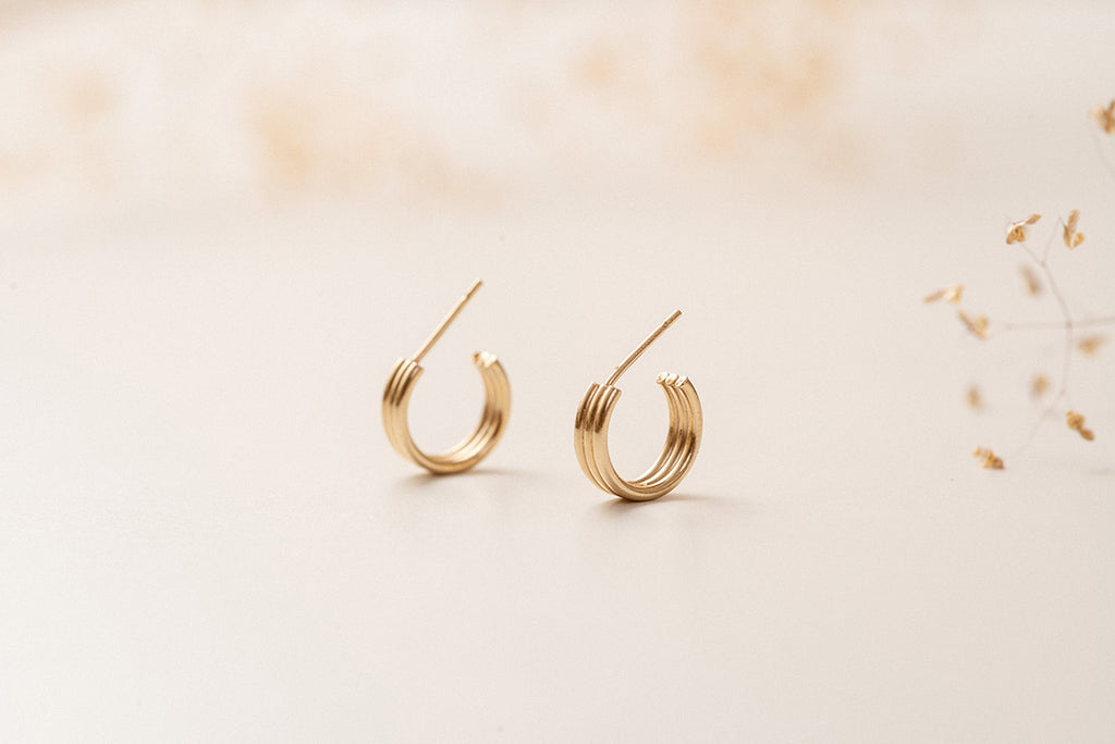 The Rouen hoop earrings by Zoaje, viewed at an angle, and made of three seamed tubes of gold-fill.
