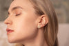 A woman wearing the Ecuador gold-fill earrings by French designers Zoaje