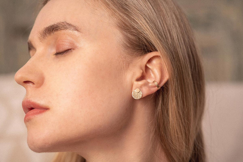 A woman wearing the Ecuador gold-fill earrings by French designers Zoaje