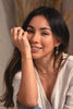 A woman wearing an elegant chain link bracelet made of yellow gold, with an OT clasp.