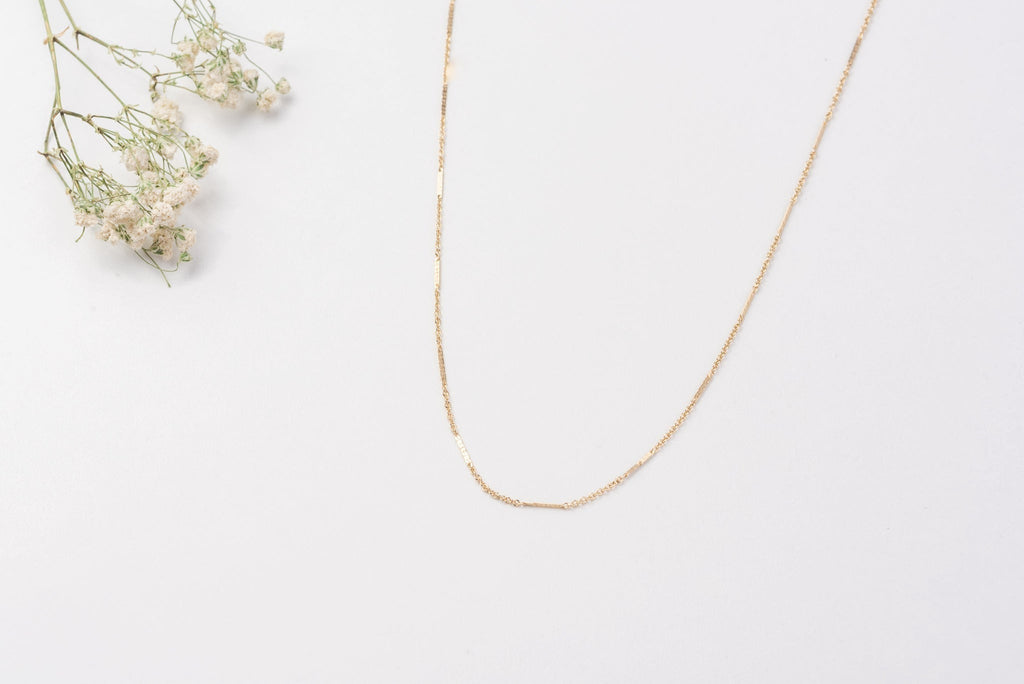 A section of the Oman necklace, a yellow gold filled chain link necklace with small (1cm approx) sections of chain flattened.
