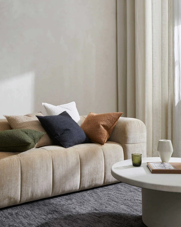 A modern living room with cream furniture, colourful cushions and the Almonte floor rug in colour coal