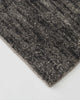 A close up of the Weave Home Almonte floor rug in colour coal, showing its beautiful mottled texture