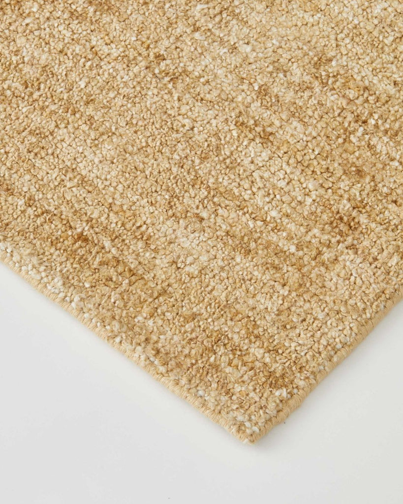 A close up of the Almonte floor rug by Weave Home in colour honeycomb, showing its subtle texture