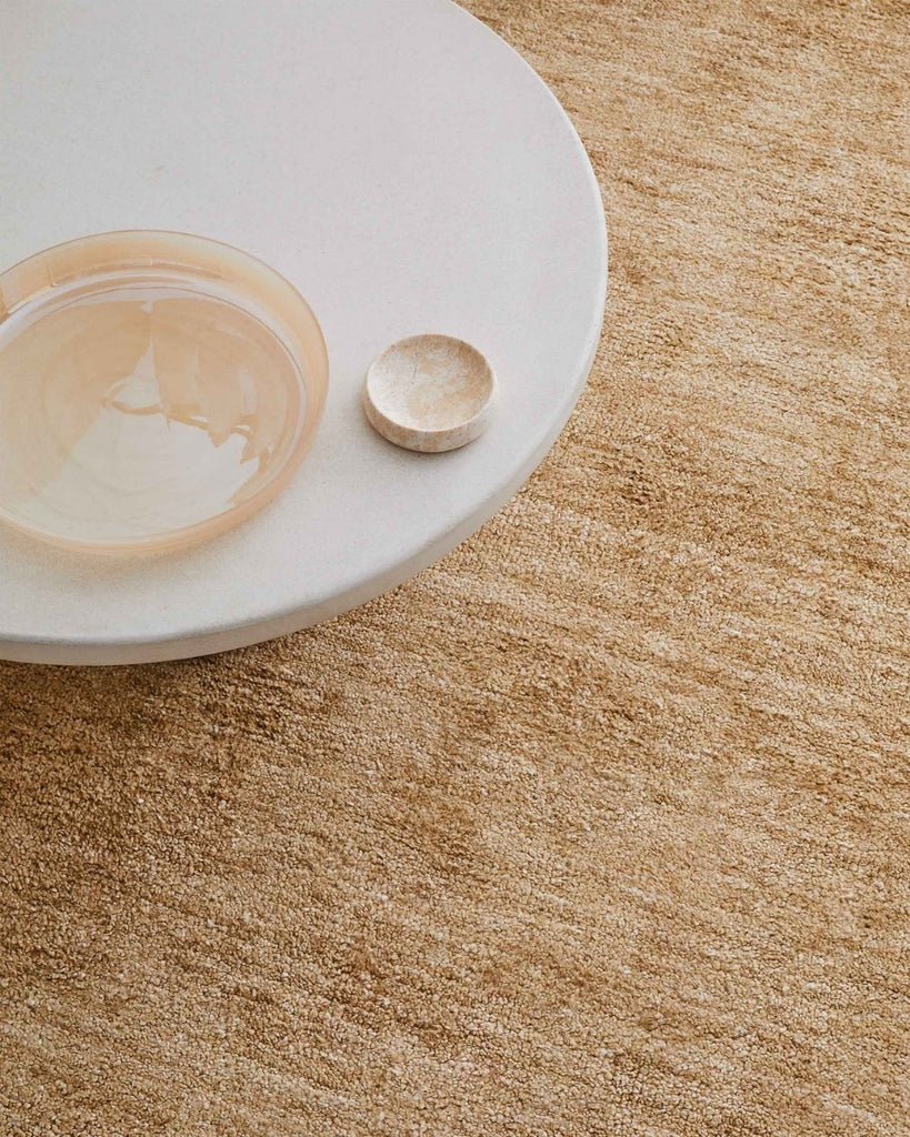 The Almonte wool blend floor rug in colour honeycomb, seen under a white coffee table