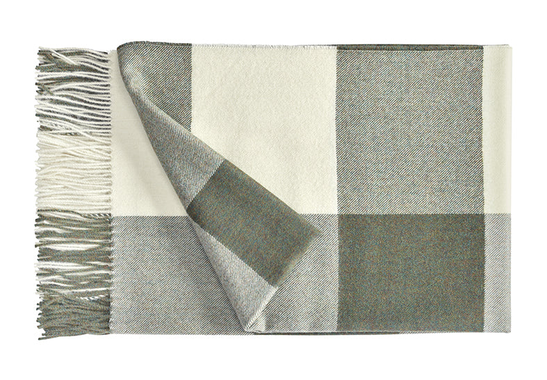 A luxurious Christian Fischbacher throw with fringe detail, made from soft warm alpaca yarn, and in a timeless green and white plaid