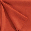 Close up of a luxurious alpaca throw, in a striking red-orange coral colour, by Christian Fischbacher