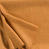 A luxurious Christian Fischbacher throw, made from soft warm alpaca yarn, and in a fashionable amber orange-yellow shade