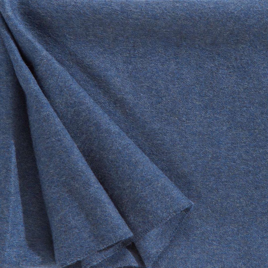 Close up of a luxurious alpaca throw, in a versatile denim blue colour, by Christian Fischbacher