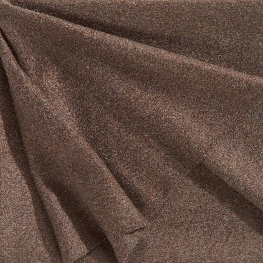 A close up of a luxurious Christian Fischbacher throw, made from soft warm alpaca yarn, and in a delicious mocha brown