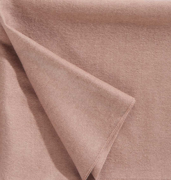 Close up of a luxurious alpaca throw, in muted dusky pink, by Christian Fischbacher