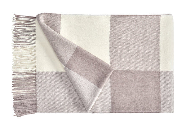 A luxurious Christian Fischbacher throw with fringe detail, made from soft warm alpaca yarn, and in a beautiful dusky-pink and white plaid