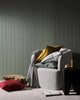 Weave Home NZ Como linen cushions stacked and styled in a mossy green  room interior