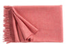A luxurious Christian Fischbacher throw, made from soft warm alpaca yarn, and in a striking watermelon blush-pink