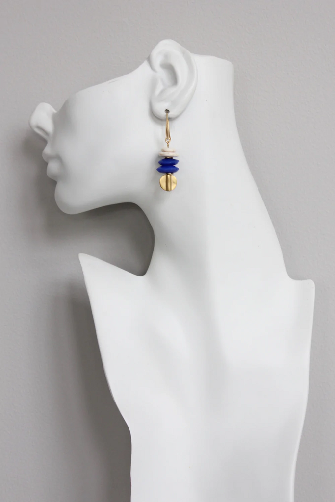 Model wearing sophisticated brass, magnesite nad blue glass dangle earrings by David Aubrey