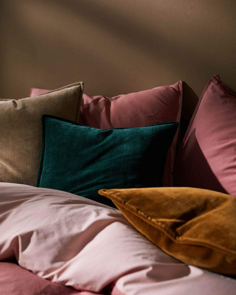 A stunning mix of velvet cushions in a bedroom setting, by Weave Home NZ