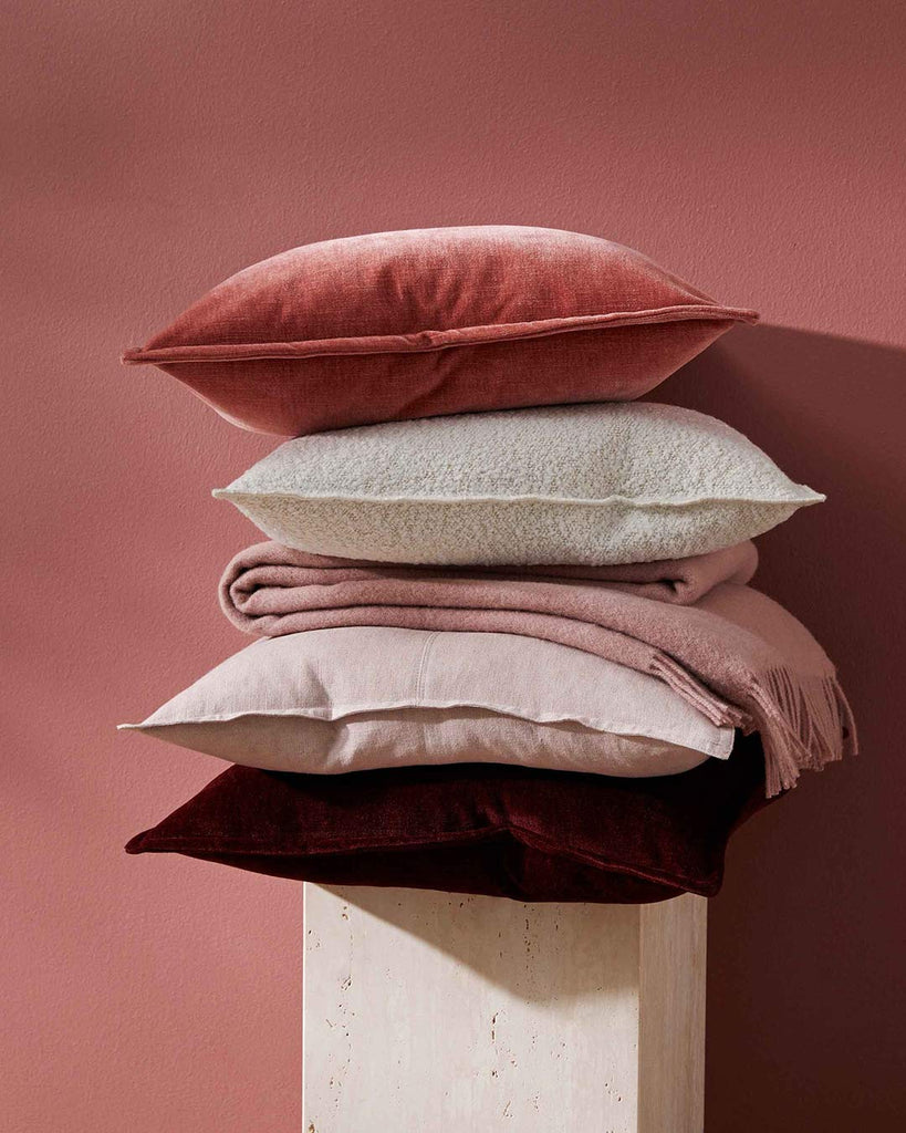 A gorgeous pile of cushions, in exquisite on-trend pinky colours, by Weave Home NZ