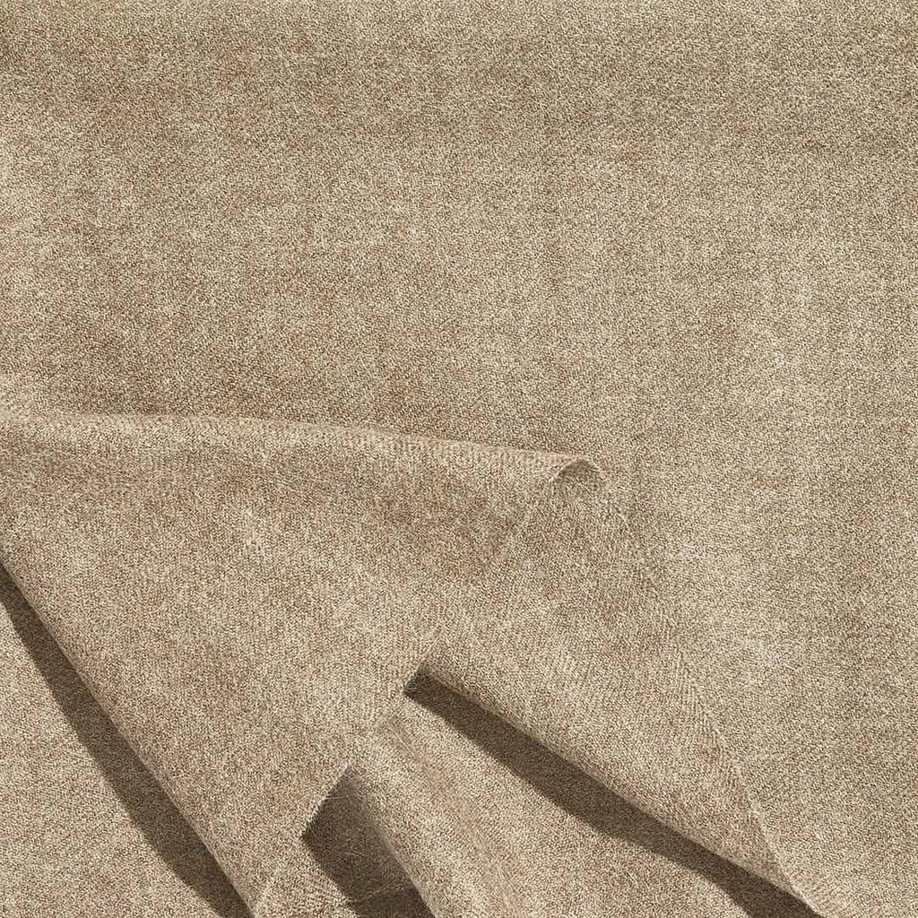 A close up of a luxurious Christian Fischbacher throw, made from soft warm alpaca yarn, and in a versatile almond brown