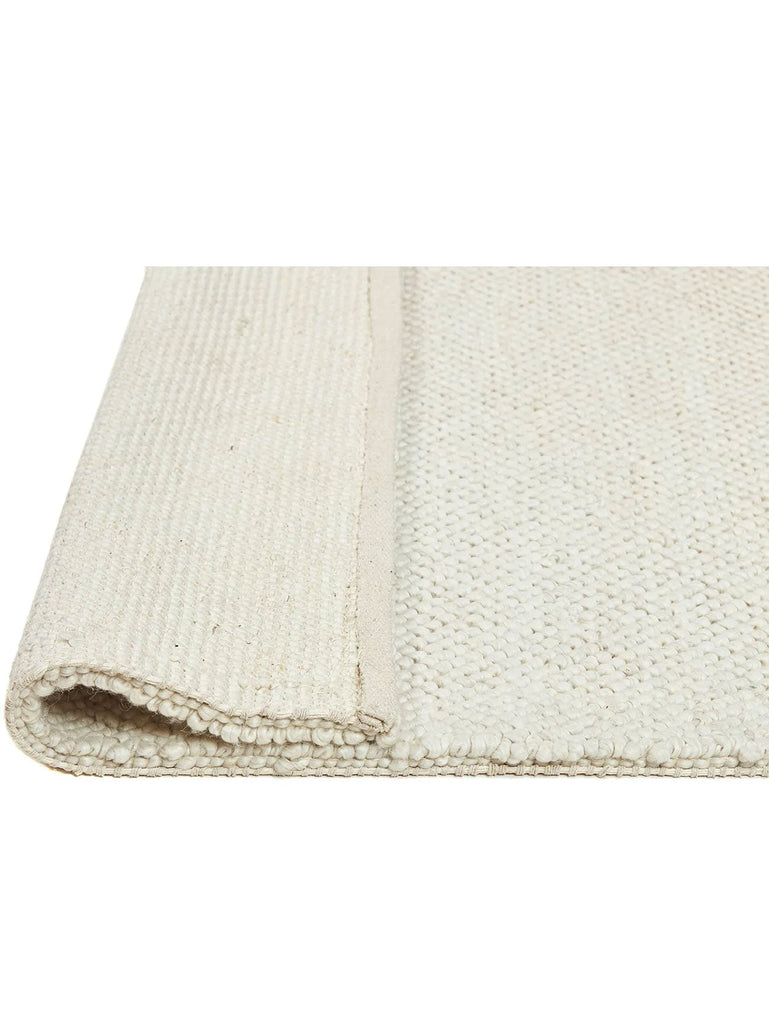 Tribe Home nz Aero rug in ivory folded for view of underneath