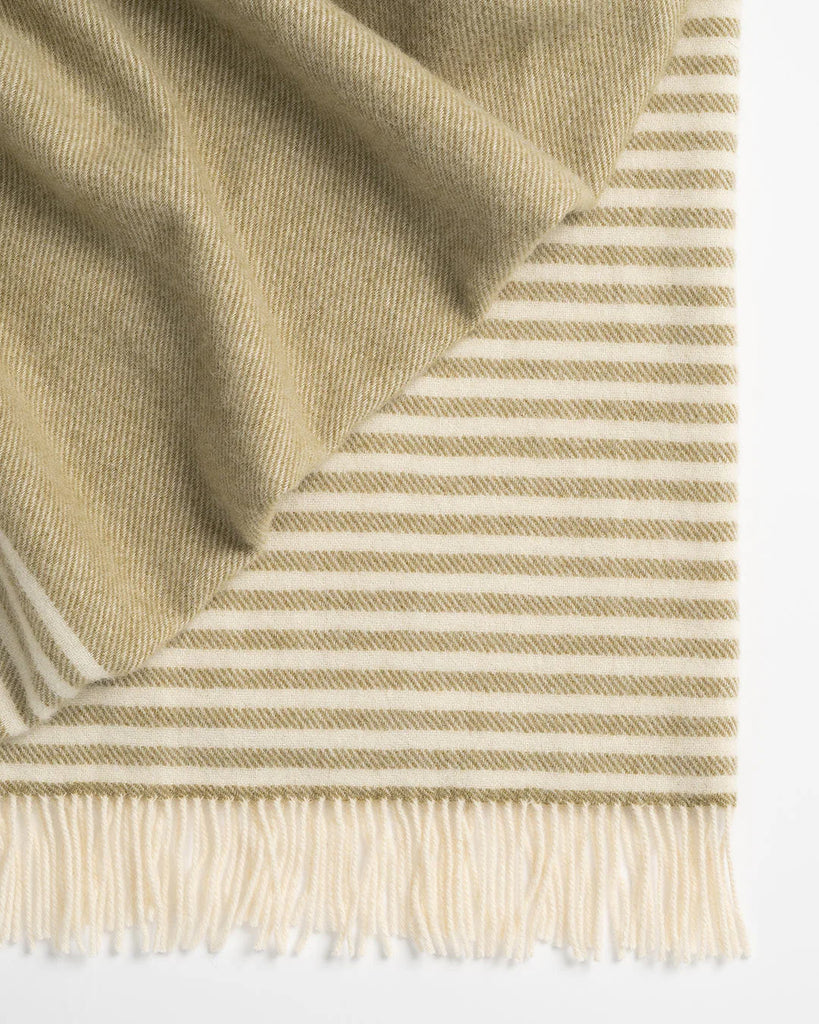 Close up of the Weave Home NZ Catlins throw blanket in green and cream stripe wool weave