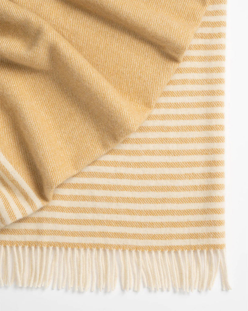 Close up of the Weave Home NZ Catlins throw in a butterscotch yellow stripe with cream