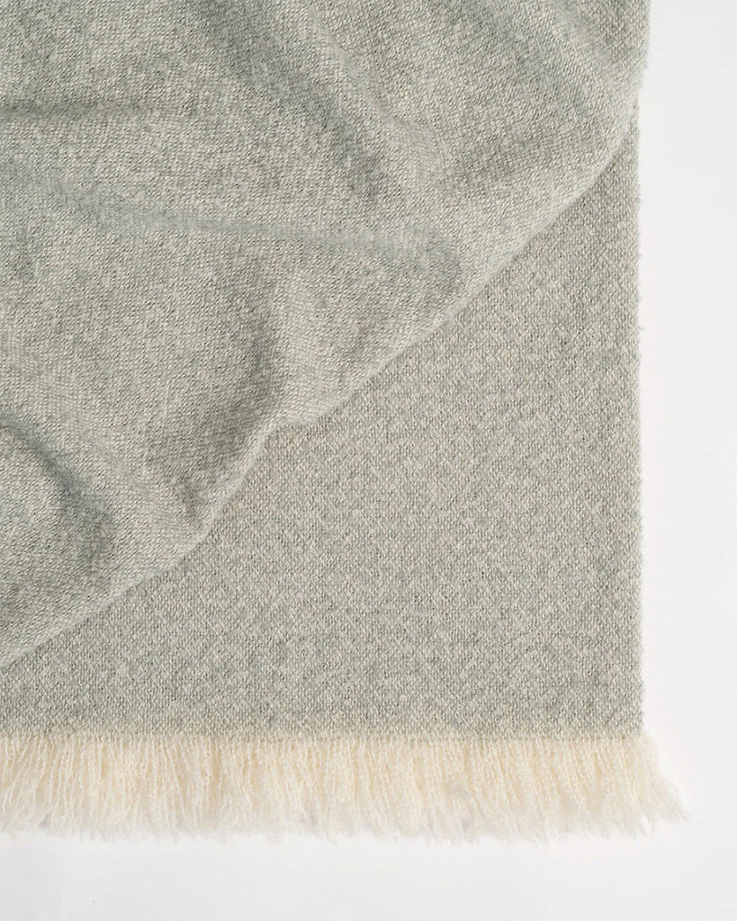 Close up of the Weave Home NZ wool boucle Clive throw blanket in colour Laurel green