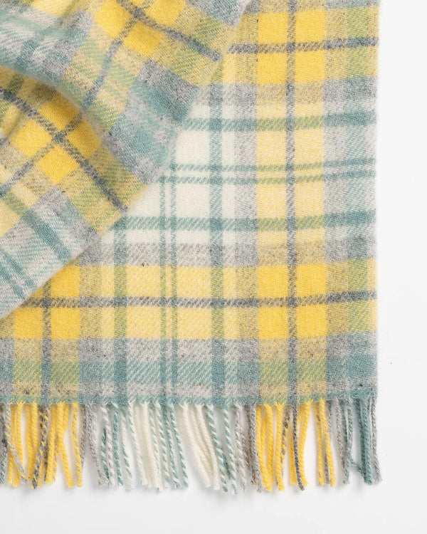Close up of the Weave Home Brighton Throw in colour butter - fetauring a sunny plaid in yellow, soft grey and sage green
