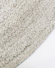 Close-up, corner view of the herringbone weave of Baya NZ's Mornington rug in Pale Sand. 