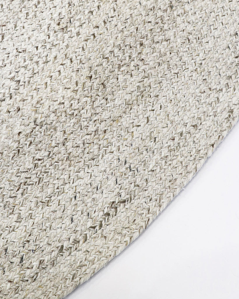Close-up, corner view of the herringbone weave of Baya NZ's Mornington rug in Pale Sand. 
