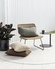 A cozy looking wicker chair with cushions by Baya NZ, sitting on a white outdoor rug, also by Baya NZ