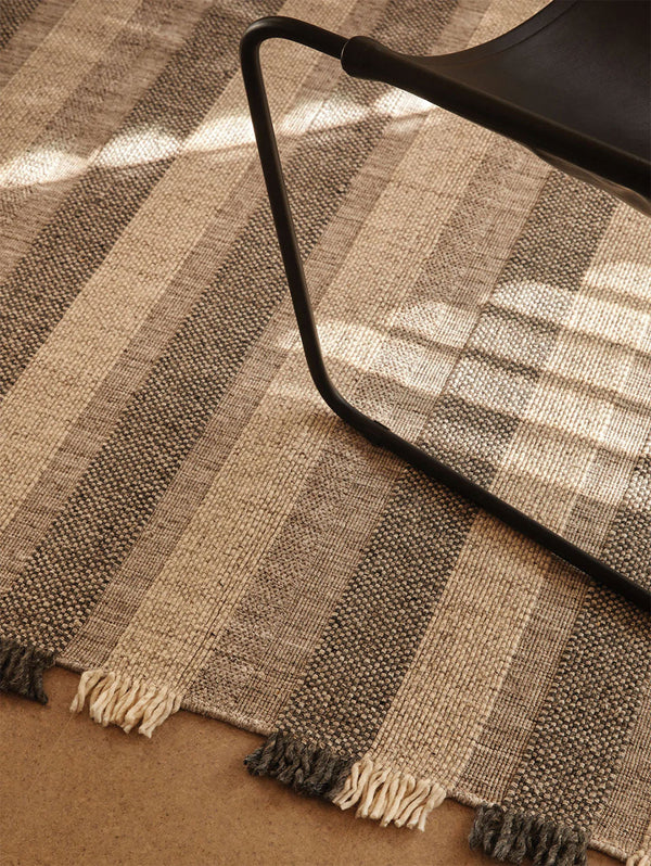 Close up of the Tribe Home nz Magnus rug under a chair leg